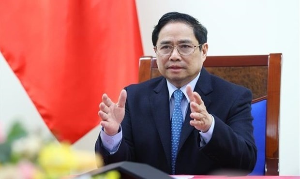 Prime Minister Pham Minh Chinh speaks at the phone talks with Chinese Premier Li Keqiang on January 13 (Photo: VNA)