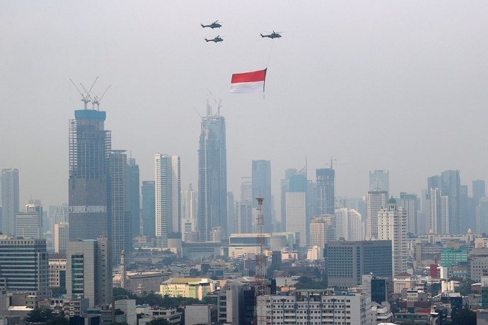  Indonesian Air Force helicopters carrying a big flag fly above high rise buildings during the country's 76th Independence Day celebrations in Jakarta, Indonesia, August 17, 2021. (Photo: Reuters)
