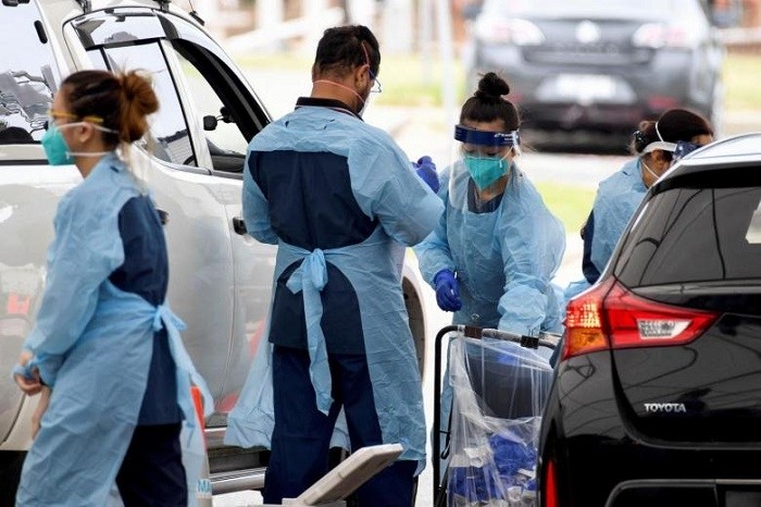 Healthcare workers administer Covid-19 tests at St Vincent's Hospital drive-through testing clinic, in Sydney, on Dec 17, 2021. (Photo: Reuters)
