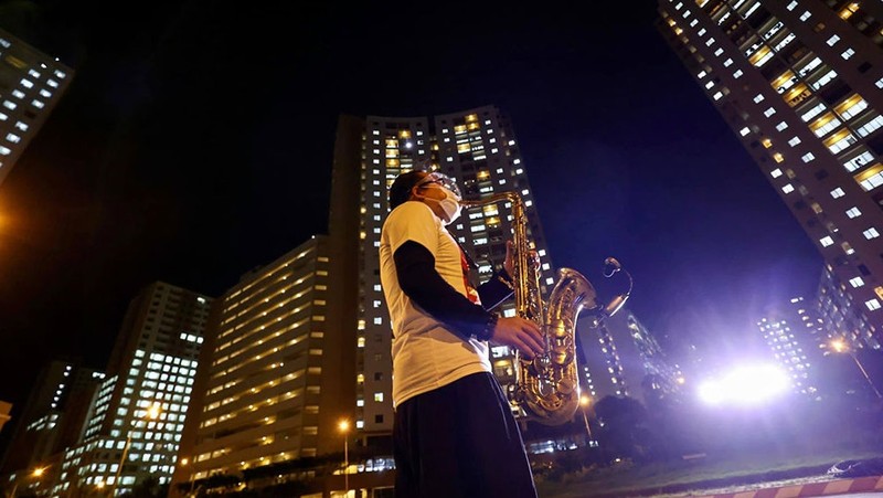 Saxophonist Tran Manh Tuan performs at a field hospital in Ho Chi Minh City.