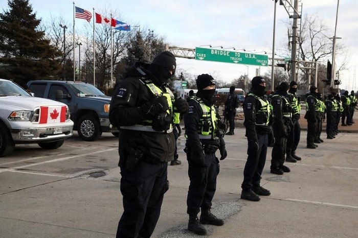 Police officers stand guard on a street in Windsor, Ontario, February 12, 2022. (Photo: Reuters) 