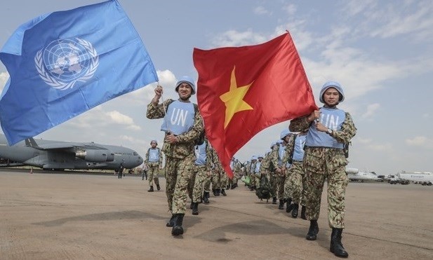 Peacekeepers hold flags of Vietnam and the UN before leaving for the UN Mission in South Sudan (Photo: VNA)