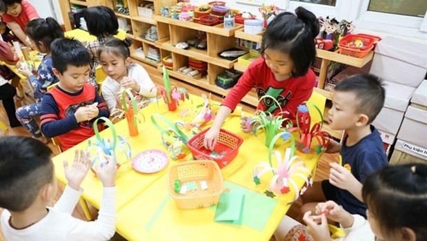 A file photo shows children of a kindergarten in Hoan Kiem District, Hanoi, playing in a class. (Photo: VNA)