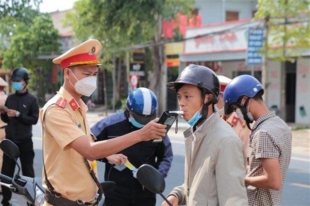 A traffic officer of Phu Thien district, the Central Highlands province of Gia Lai, administering a breathalyser test on a road user during rush hour. (Photo: VNA)