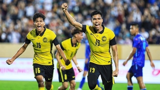 Malaysian players celebrate their goal. (Photo: VNA)
