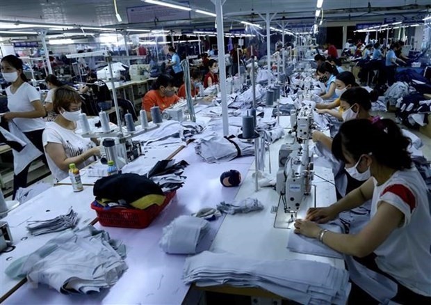 At a garment factory (Photo: VNA)
