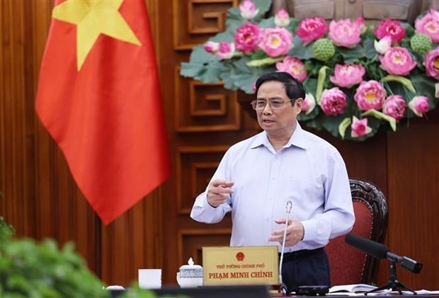 Prime Minister Pham Minh Chinh speaks at the meeting in Hanoi on June 23. (Photo: VNA)