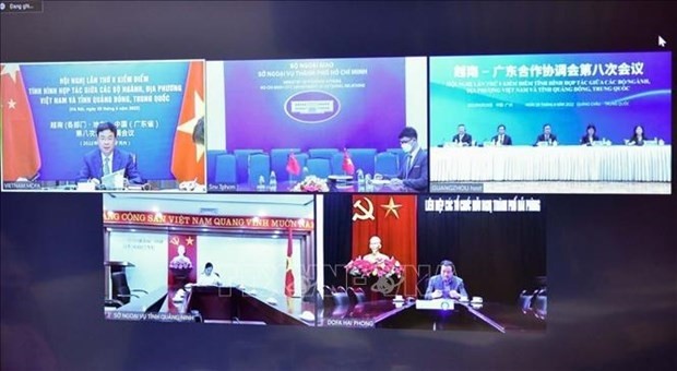 Vietnamese and Chinese officials take part in the teleconference on June 29. (Photo: VNA)