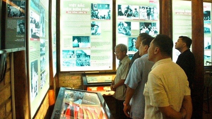 Visitors admire photos and documents on display at the museum.