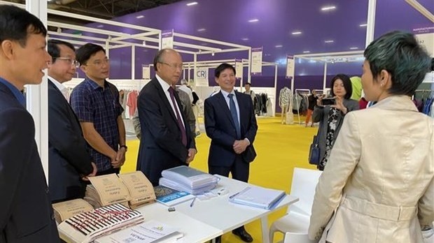 Vietnamese Ambassador to France Dinh Toan Thang (fourth from the left) visits a Vietnamese booth at the event. (Photo: VNA)
