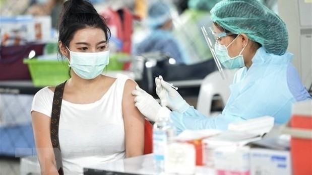 A health worker gives a person a dose of the COVID-19 vaccine in Bangkok, Thailand. (Photo: Xinhua/VNA)