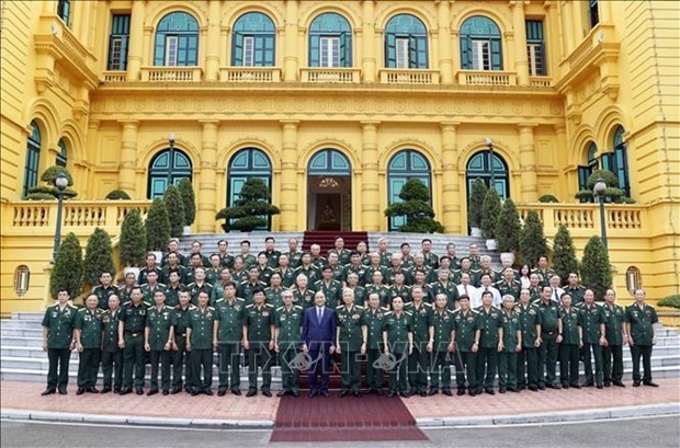 President Nguyen Xuan Phuc and war veterans pose for a group photo. (Source: VNA)