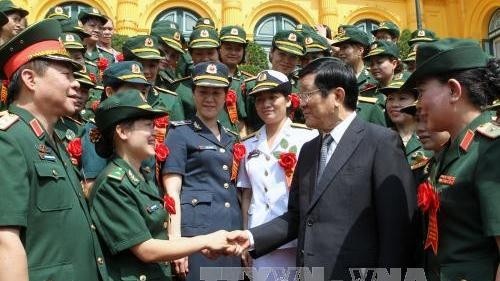 President Truong Tan Sang and the outstanding  army women at the meeting (Photo: VNA)