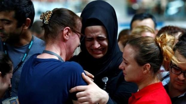 Airport employees mourn for their friends, who were killed in Tuesday's attack at the airport, during a ceremony at the international departure terminal of Ataturk airport in Istanbul, Turkey. (Credit: Reuters)