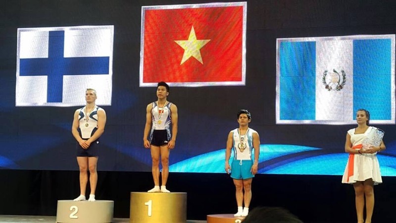 Nguyen Tuan Dat (centre) wins the men's vault gold medal.