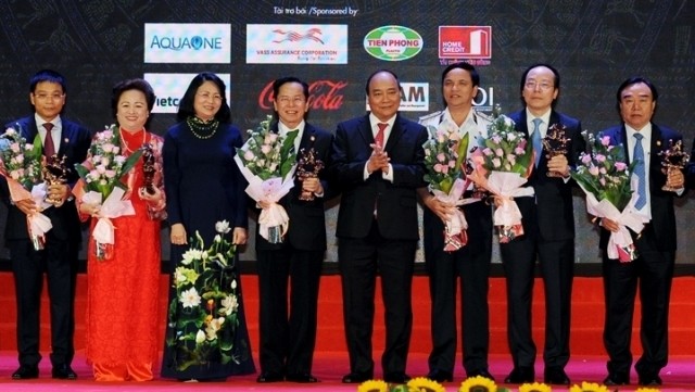 PM Nguyen Xuan Phuc (fourth from right) and Vice President Dang Thi Ngoc Thinh (third from left) present the Thanh Giong Cup to prominent entrepreneurs of 2016 at a ceremony held in Hanoi on October 11 on the occasion of Vietnam Entrepreneurs’ Day (October 13). (Credit: NDO)