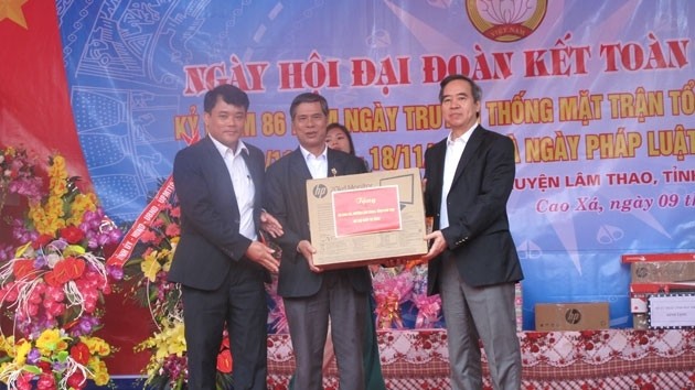 Politburo member Nguyen Van Binh presents gifts to residents of Cao Xa commune.