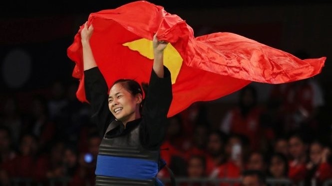Pham Thi Tuoi celebrates after taking the 45-50kg gold medal.