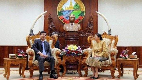 Lao NA Chairwoman Pany Yathotou (right) receives Minister of Justice Le Thanh Long. 