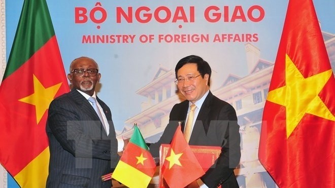 Deputy Prime Minister and Minister Pham Binh Minh (R) and Cameroon Foreign Minister Lejeune Mbella Mbella at the signing ceremony of bilateral agreements (Photo: VNA)