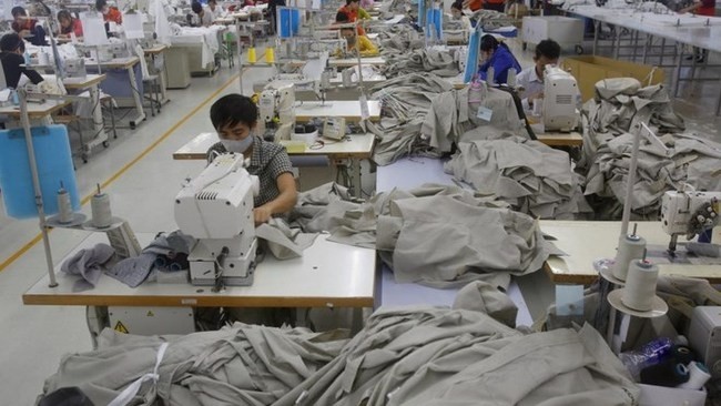 Labourers work at a garment factory in Hung Yen province (Credit: Reuters)