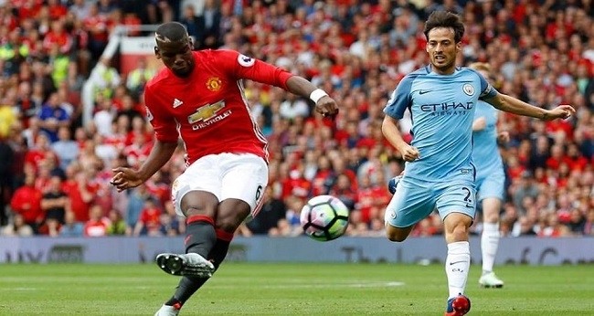 Manchester United's Pogba takes on Manchester City's Silva during the match at the Etihad on Saturday (April 7). (Photo: Reuters)   