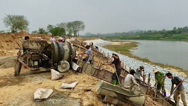 Workers fortify a section of the dyke along the Pho Day River in the northern province of Vinh Phuc. (Photo: baovinhphuc.com.vn)