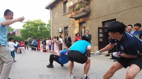 A game of tug-of-war between staff of the Vietnamese and Lao embassies in China