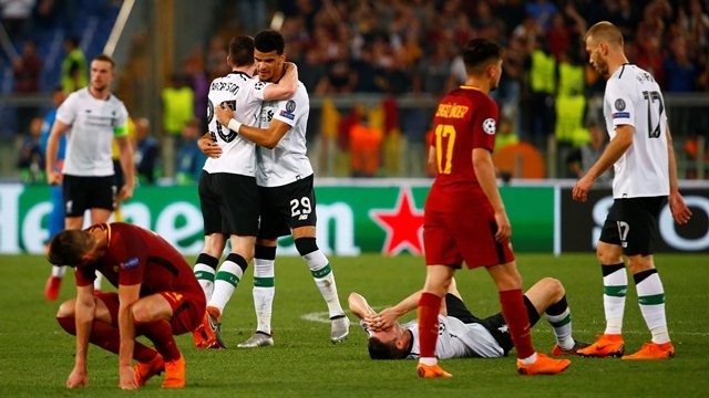 Liverpool's Dominic Solanke and Andrew Robertson celebrate as Roma players look dejected after the match. (Photo: Reuters)