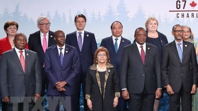 Prime Minister Nguyen Xuan Phuc (third, right, second line) and delegates to G7 Summit and G7 Outreach Summit. (Photo: VNA)