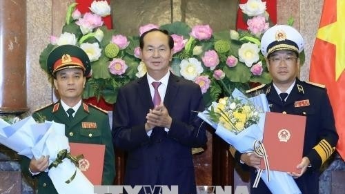 President Tran Dai Quang and two newly promoted military officers