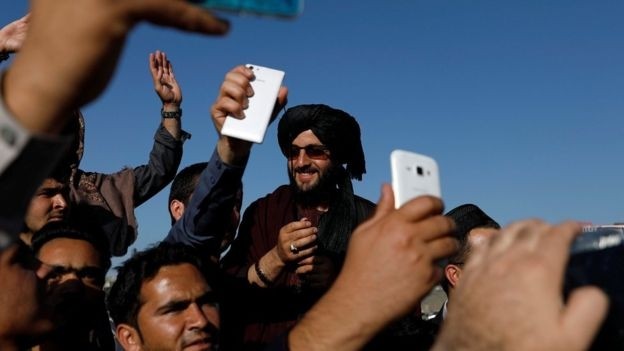 Afghans take selfies with the Taliban militants in Kabul. (Photo: Reuters)
