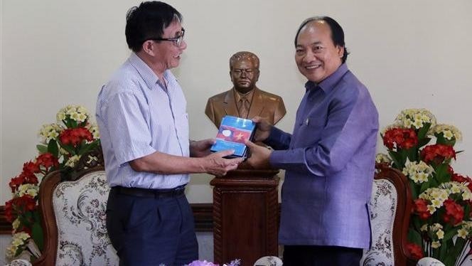 President of the Vietnam Cinema Association Dang Xuan Hai (L) presents the documentary to acting head of the Khaysone Phomvihane Museum Singthong Singhapanya. (Photo: VNA)