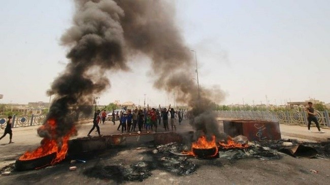 Iraqi protesters burn tyres to block roads around Basra. (Photo: Reuters)