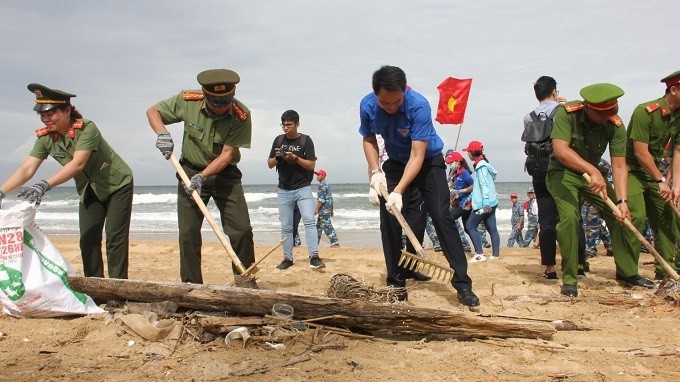 Delegates participate in coastal cleanup in response to the "Clean the Sea" campaign.