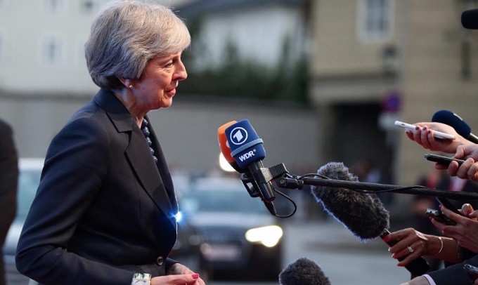 UK PM Theresa May talks to the media as she arrives for the informal meeting of EU leaders ahead of the EU summit, in Salzburg, Austria, September 19, 2018. (Reuters)