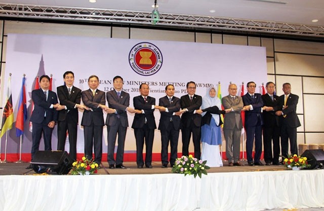 ASEAN law ministers show their solidarity at the opening session of the 10th ASEAN Law Ministers Meeting in Vientiane on October 12.