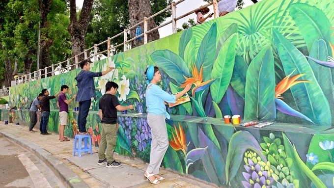 Artists are putting the final touches to a mural on Pho Duc Chinh Street in Hanoi.