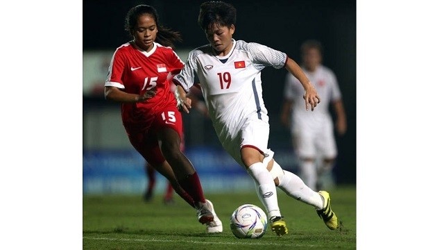 Vietnam team (in white) crushed Singapore 11-0 in the match took place yesterday.