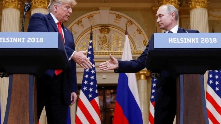 US President Donald Trump and Russia’s President Vladimir Putin shake hands during a joint news conference after their meeting in Helsinki, Finland on July 16, 2018. (Reuters)