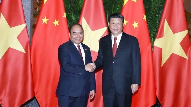 Prime Minister Nguyen Xuan Phuc (left) and Chinese Party General Secretary and President Xi Jinping (Photo: VGP)