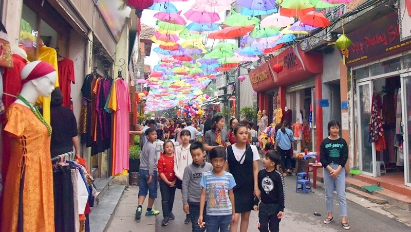 A 100-metre street in the village is adorned with open umbrellas during the event