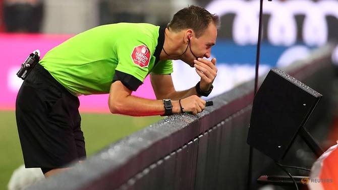 A referee consults the Video Assistant Referee system during a Bundesliga match between Bayern Munich and TSG 1899 Hoffenheim at the Allianz Arena. (Reuters)