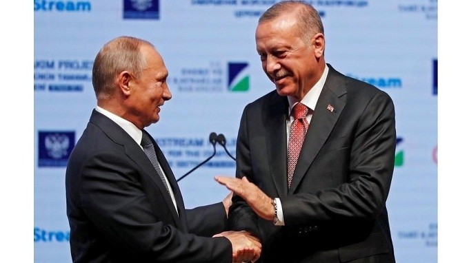Turkish President Tayyip Erdogan (right) and his Russian counterpart Vladimir Putin shake hands as they attend a ceremony to mark the completion of the sea part of the TurkStream gas pipeline, in Istanbul, Turkey November 19, 2018. REUTERS/Murad Sezer