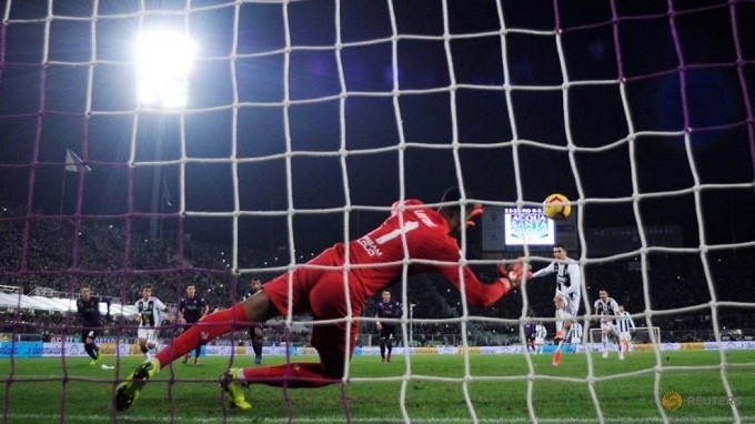 Juventus' Cristiano Ronaldo scores their third goal from the penalty spot. (Reuters)