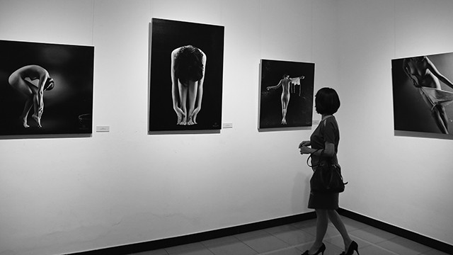 A visitor admiring the photos on display at the first-ever nude photo exhibition in Hanoi in July 