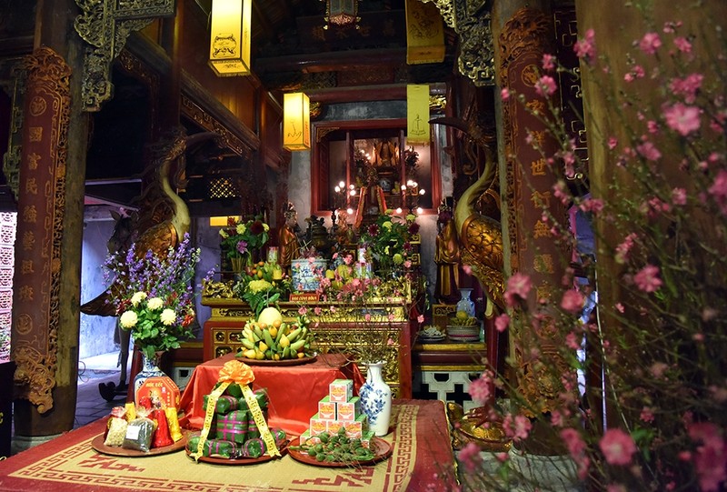 On the altar inside Kim Ngan temple, traditional Tet tray with traditional dishes and five-fruits tray.