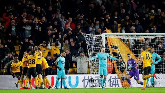 Wolverhampton Wanderers' Willy Boly celebrates scoring their first goal with team mates as Newcastle players look dejected - Premier League - Wolverhampton Wanderers v Newcastle United - Molineux Stadium, Wolverhampton, Britain - February 11, 2019. (Photo: Reuters)