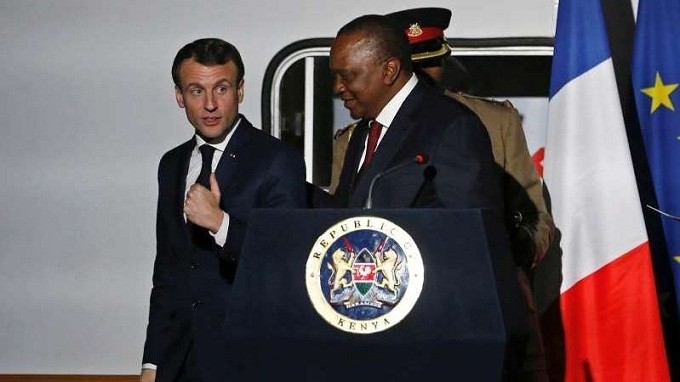 French President Emmanuel Macron talks to Kenya's President Uhuru Kenyatta as they leave a news conference after touring the Nairobi Central Railway in Nairobi, Kenya. (Reuters)