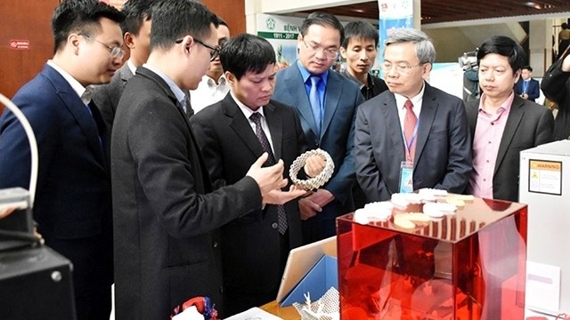 Delegates tour the exhibition "Youth creativity of the Hanoi health sector" on March 17.